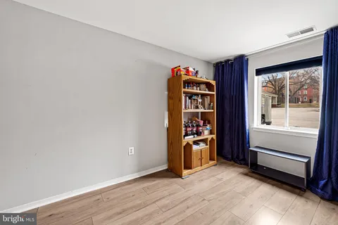 an empty room with wooden floor and closet