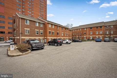 a view of a cars park in front of a building