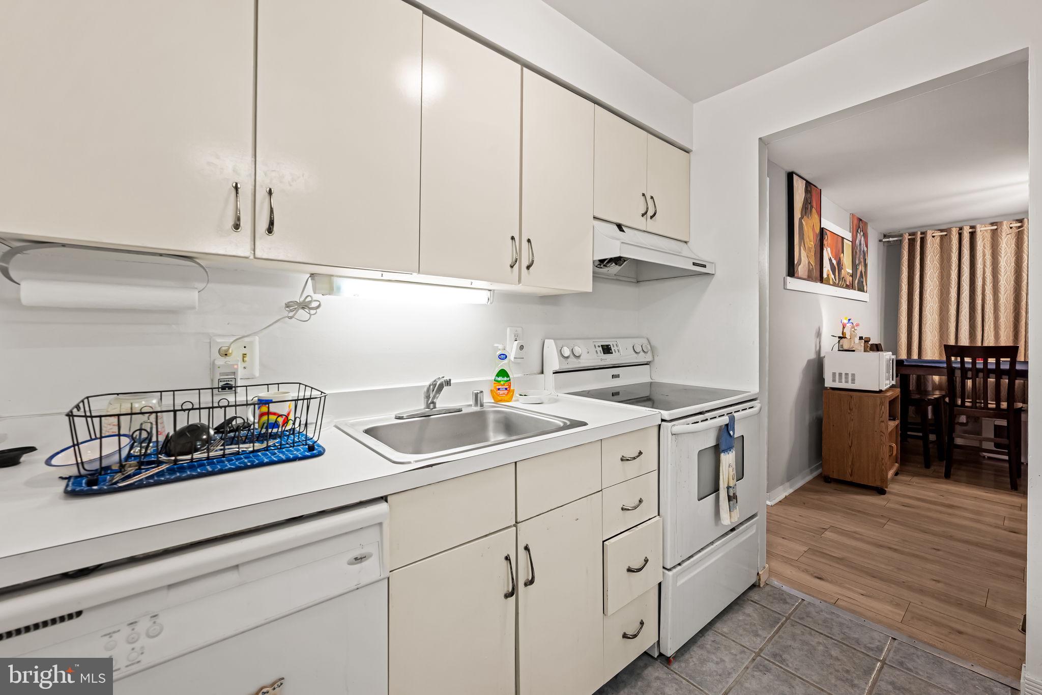 526 South Charles Street, Unit R79 Baltimore, MD 21201 - Photo 9 of 21 a kitchen with white cabinets and white appliances