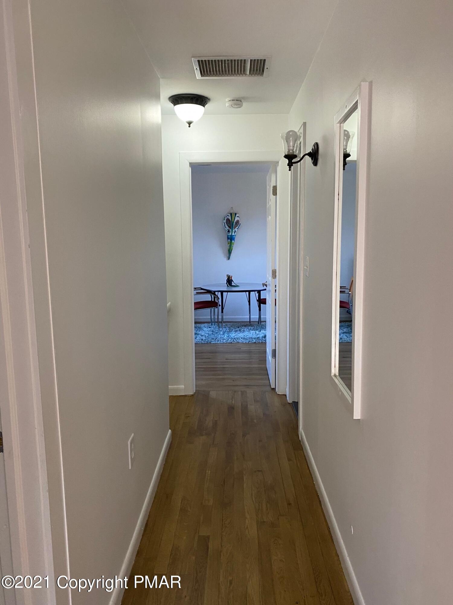 337 Tara Hill Road Bartonsville, PA 18321 - Photo 28 of 37 a view of a hallway with a livingroom and furniture