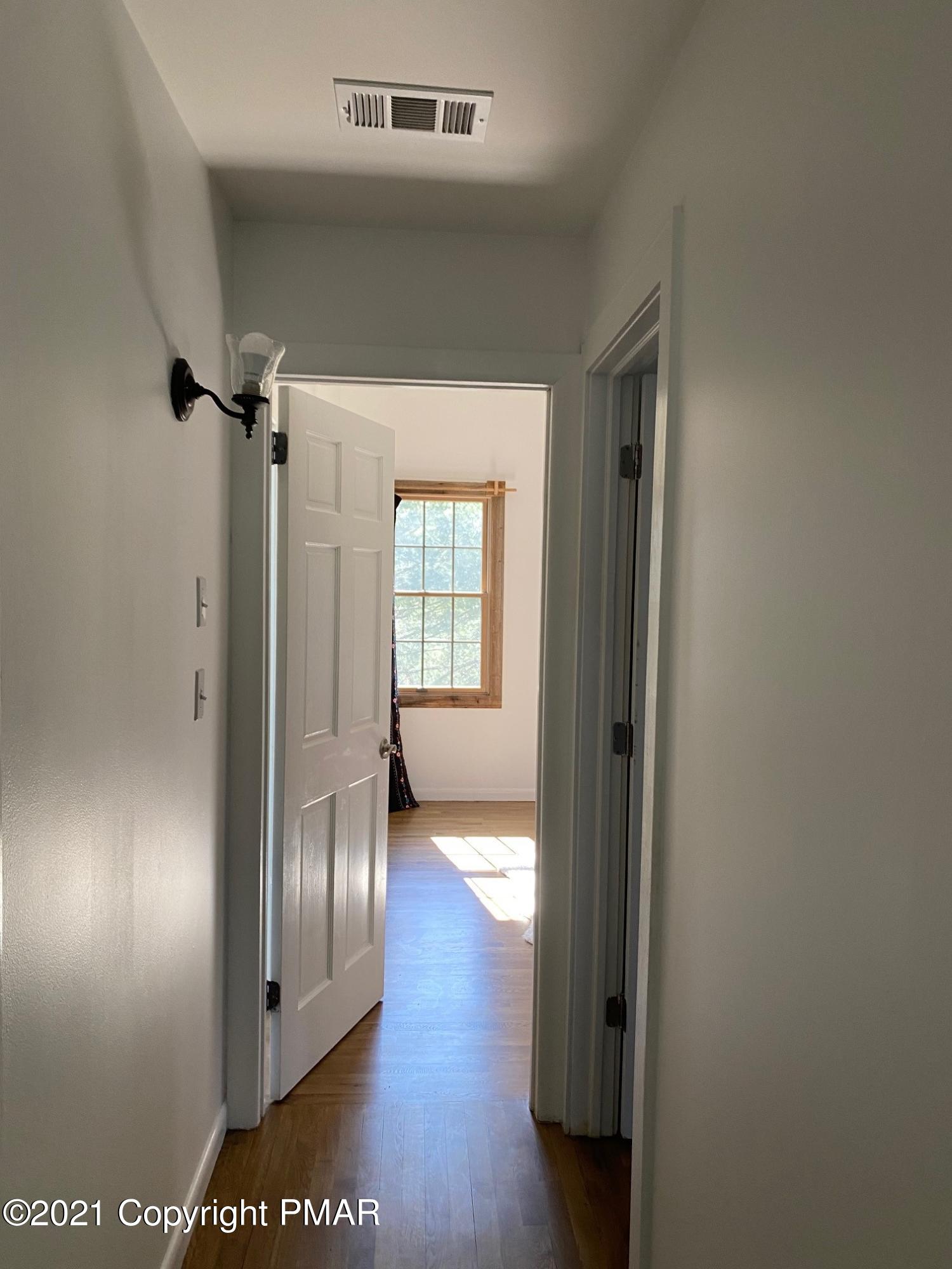 337 Tara Hill Road Bartonsville, PA 18321 - Photo 34 of 37 a view of a hallway with wooden floor and glass door
