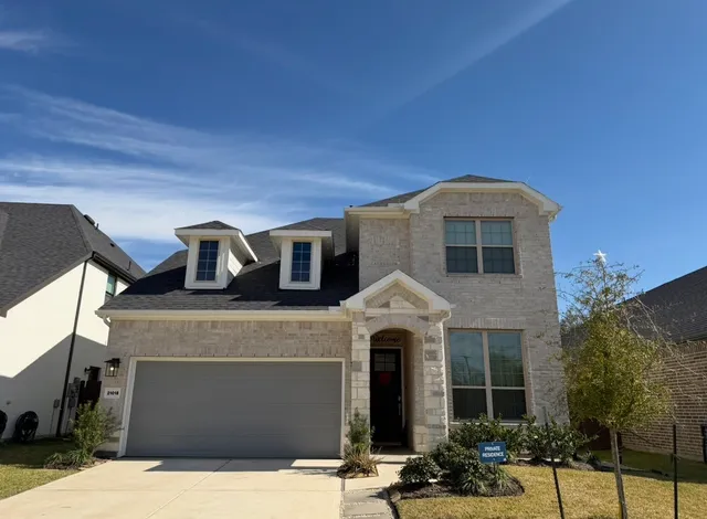 a front view of a house with yard