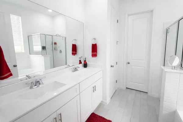 a bathroom with a sink vanity tub and shower