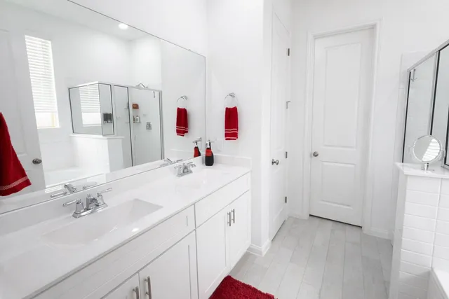 a bathroom with a sink vanity tub and shower