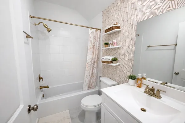 a bathroom with a sink toilet and shower