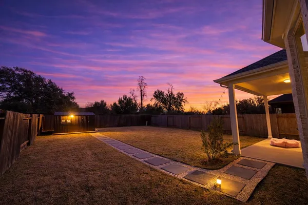 a view of a backyard with a patio