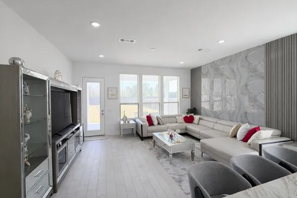 a living room with furniture and a flat screen tv