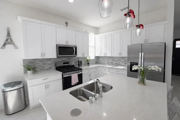 a kitchen with a sink a stove and refrigerator