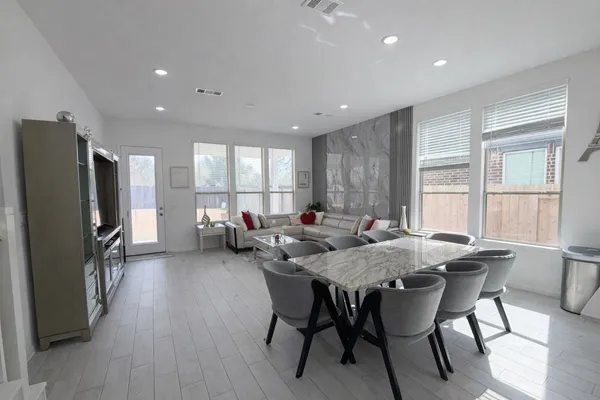 a view of a dining room with furniture window and wooden floor