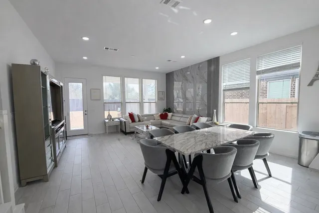 a view of a dining room with furniture window and wooden floor