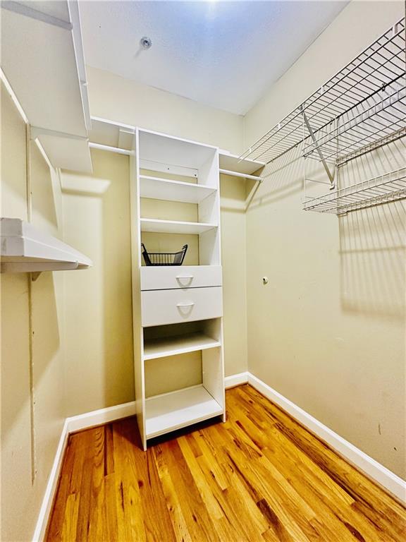 3777 Peachtree Road Northeast, Unit 1212 Atlanta, GA 30319 - Photo 14 of 27 a bedroom with a bed and a table