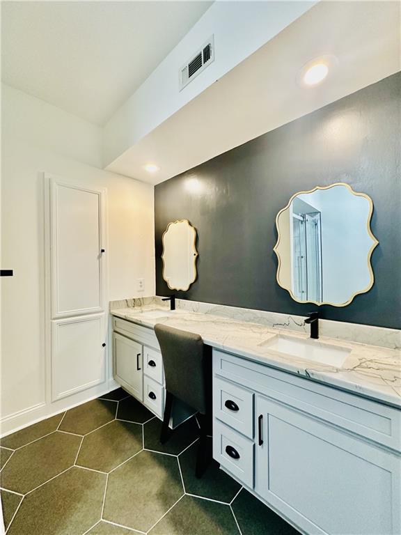 3777 Peachtree Road Northeast, Unit 1212 Atlanta, GA 30319 - Photo 16 of 27 a spacious bathroom with a double vanity sink and a mirror