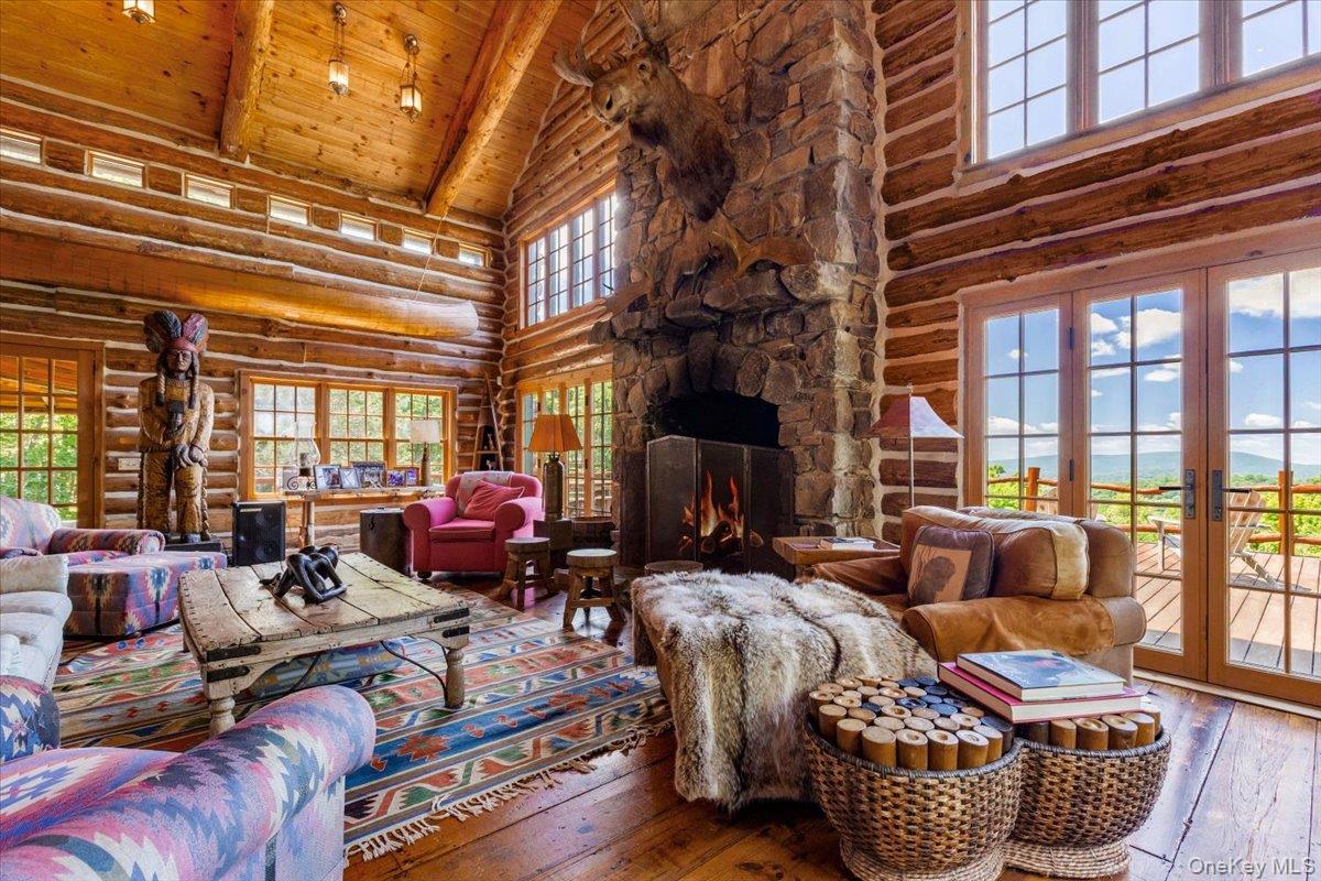 367 Prospect Hill Road Ancramdale, NY 12503 - Photo 28 of 50 Living area with high vaulted ceiling, rustic walls, hardwood / wood-style floors, a wood ceiling with exposed beams, and french doors