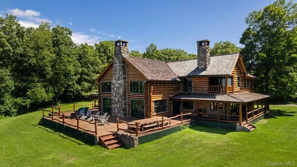 a view of a house with patio and a yard