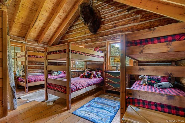 a bedroom with bunk bed and a window