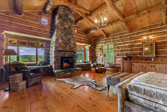 a kitchen with stainless steel appliances granite countertop a stove top oven a dining table and chairs with wooden floor