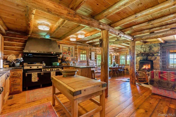 a kitchen with stainless steel appliances granite countertop a stove a sink dishwasher and cabinets with wooden floor