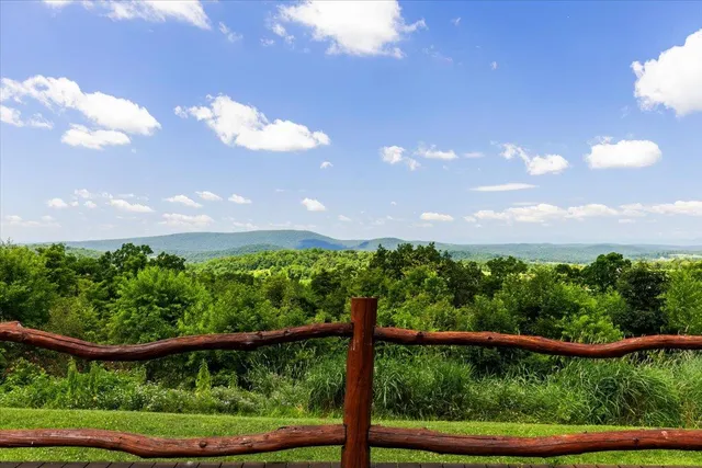 a view of a yard with a street from a window