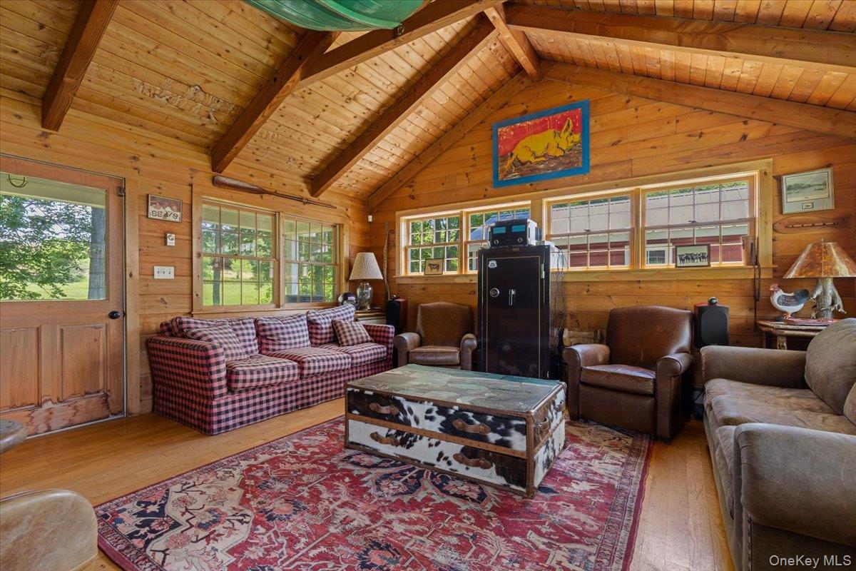 367 Prospect Hill Road Ancramdale, NY 12503 - Photo 43 of 50 Living area with wood-type flooring, plenty of natural light, wood walls, and wooden ceiling