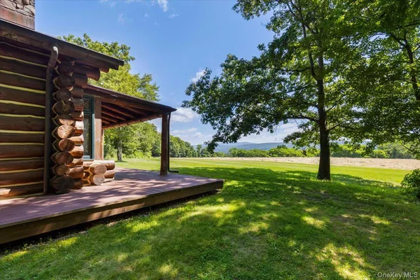 a terrace of a house with wooden floor and outdoor seating