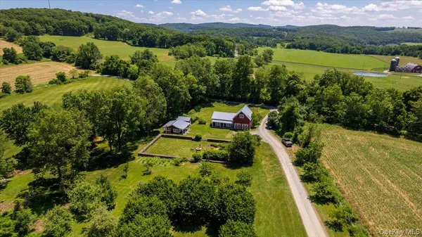 a view of a big yard with table and chairs