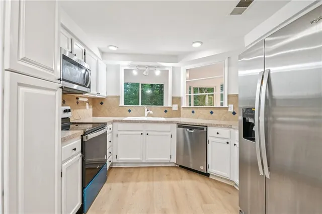 a kitchen with a sink stove and refrigerator