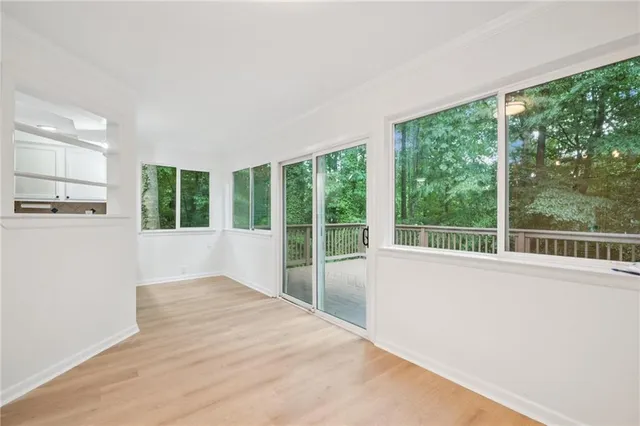 a view of a kitchen with wooden floor and windows