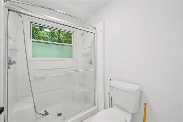 a bathroom with a shower and toilet