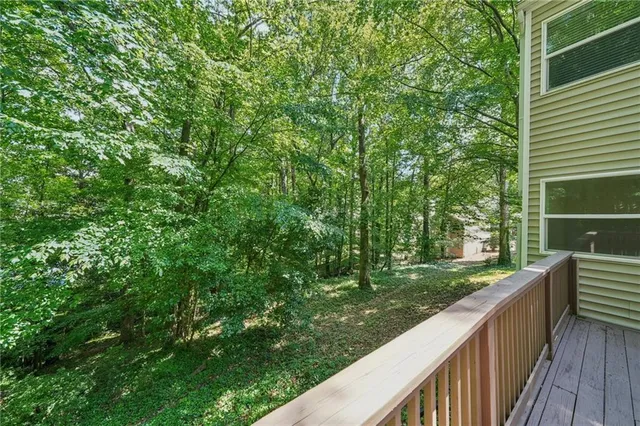 a view of a wooden deck next to a yard
