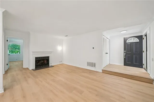 a view of an empty room with a fireplace