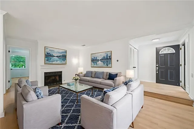 a living room with furniture a fireplace and a painting