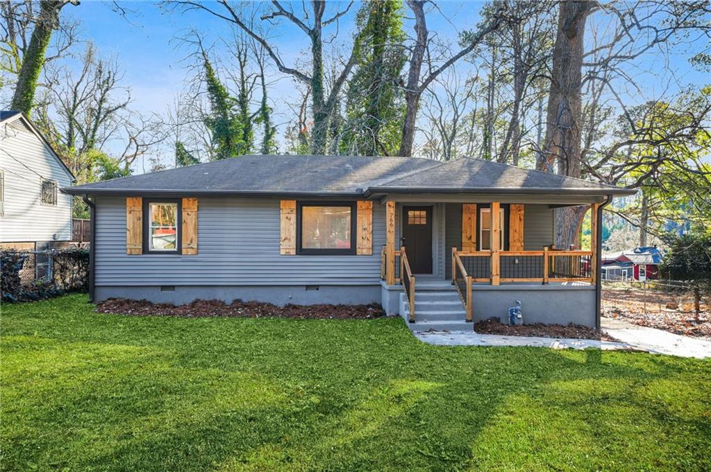 a front view of a house with a garden