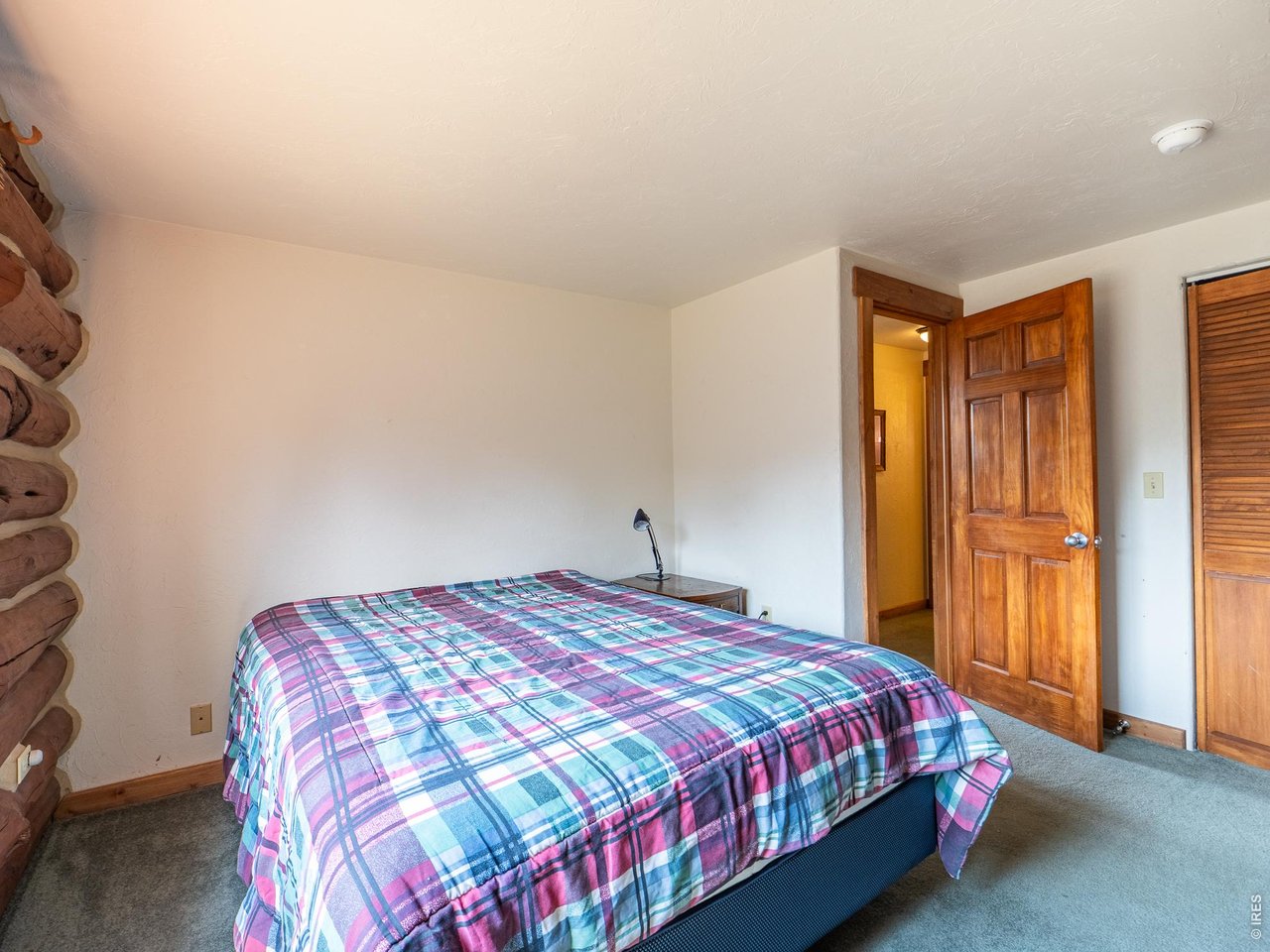296 Caddo Road Red Feather Lakes, CO 80545 - Photo 17 of 50 Main floor bedroom with a nice mix of log & drywall.