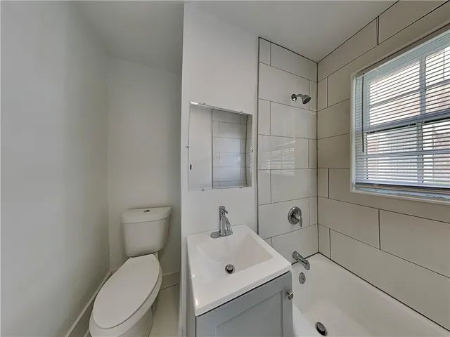 a white toilet sitting next to a bathroom sink