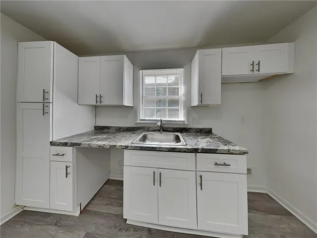 a kitchen with cabinets appliances and a sink