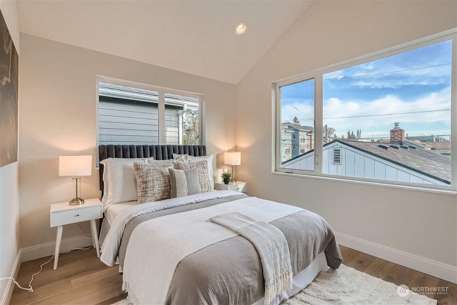 3419 36th Avenue South, Unit A Seattle, WA 98144 - Photo 12 of 23 a bedroom with a large bed and a lamp