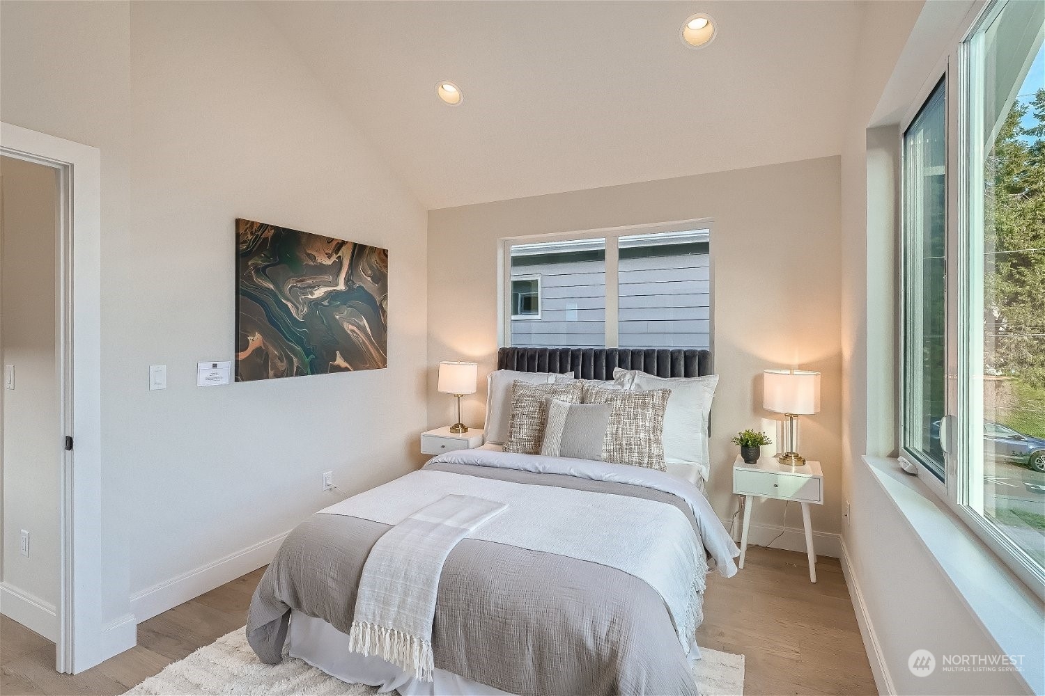 3419 36th Avenue South, Unit A Seattle, WA 98144 - Photo 13 of 23 a bedroom with a bed and a painting on the wall