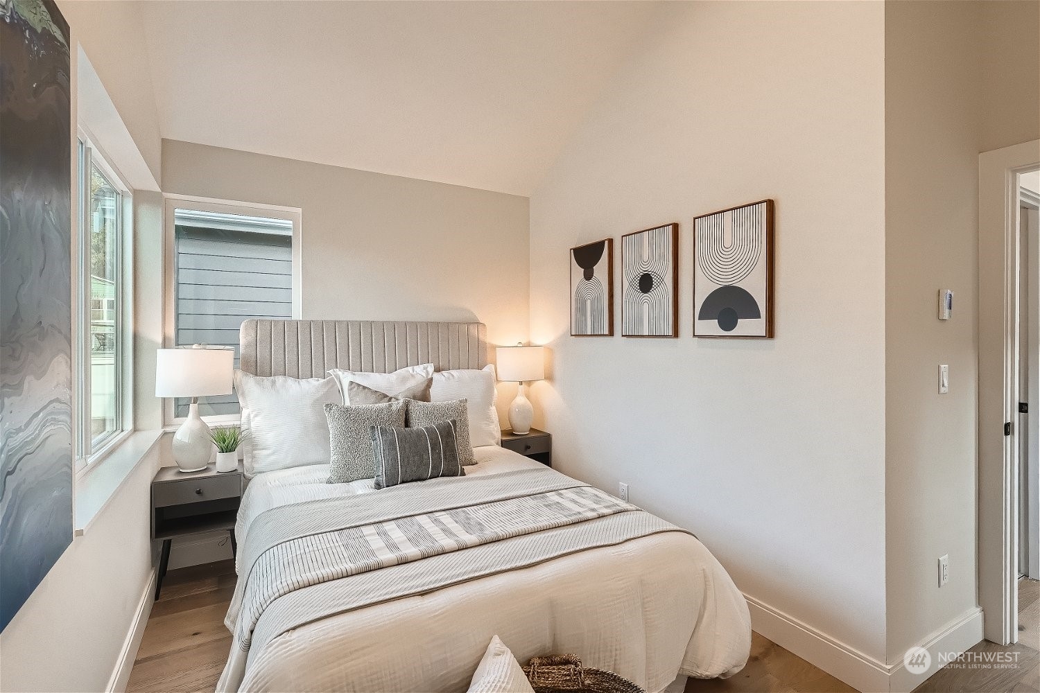 3419 36th Avenue South, Unit A Seattle, WA 98144 - Photo 18 of 23 a bedroom with a white bed and wooden floor