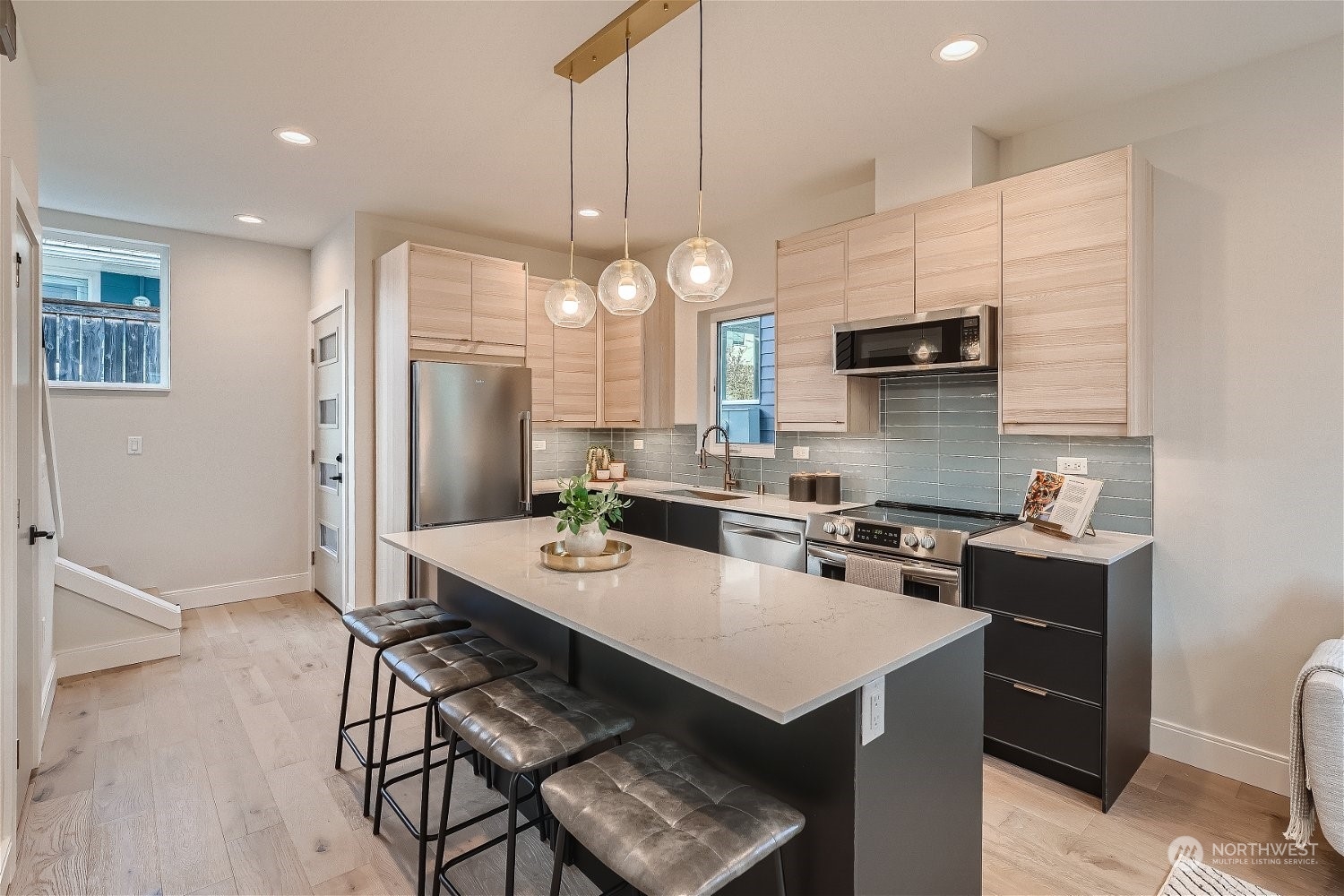 3419 36th Avenue South, Unit A Seattle, WA 98144 - Photo 10 of 23 a kitchen with a dining table cabinets appliances and wooden floor