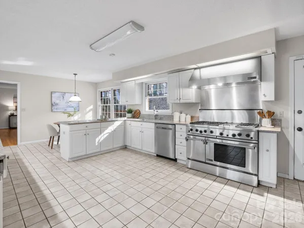 a kitchen with stainless steel appliances a sink and a stove top oven