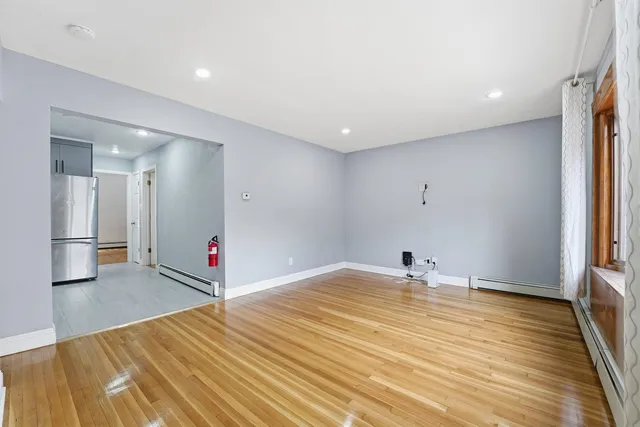 a kitchen with stainless steel appliances kitchen island granite countertop a refrigerator and a sink
