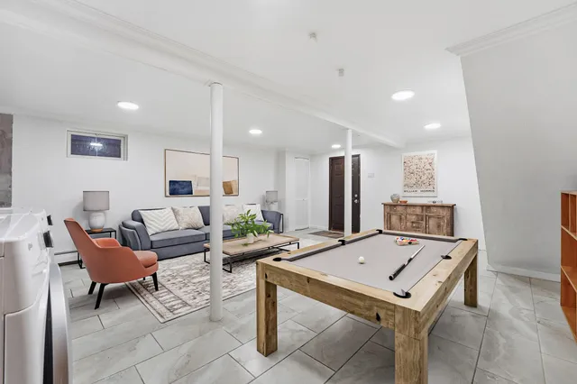 a kitchen with granite countertop a sink cabinets stainless steel appliances and a window