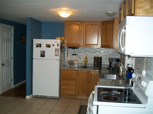 80 Mallowhill Road Springfield, MA 01129 - Photo 6 of 30 a kitchen with granite countertop a refrigerator a sink a stove and cabinets