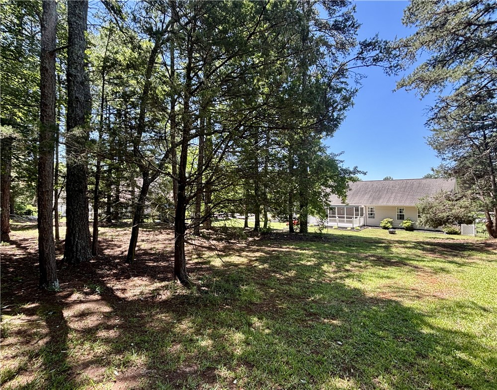 848 Perkins Creek Road Seneca, SC 29678 - Photo 3 of 26 A tranquil wooded setting frames this charming single-story residence with a welcoming screened porch.