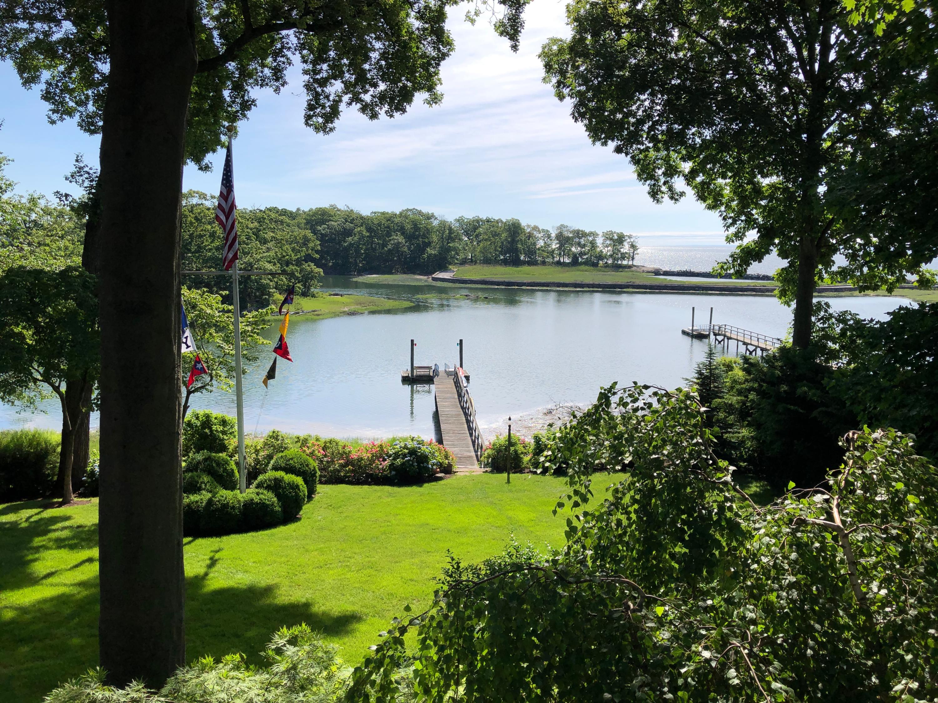 123 Long Neck Point Road Darien, CT 06820 - Photo 1 of 41 a view of a lake with houses in the back