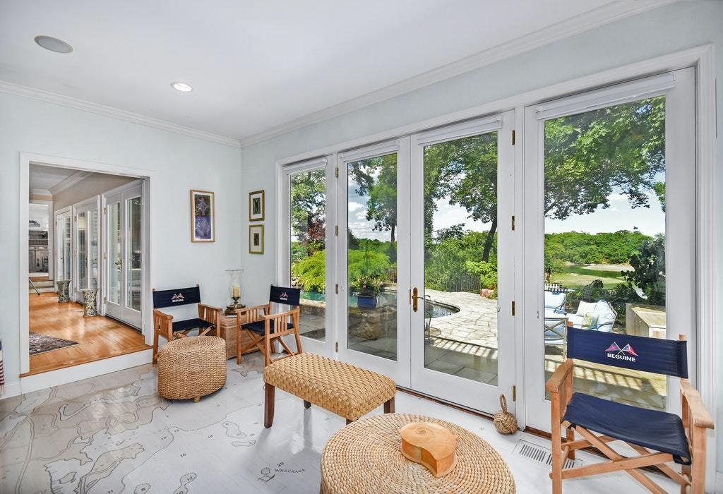 123 Long Neck Point Road Darien, CT 06820 - Photo 17 of 41 a living room with furniture and a floor to ceiling window