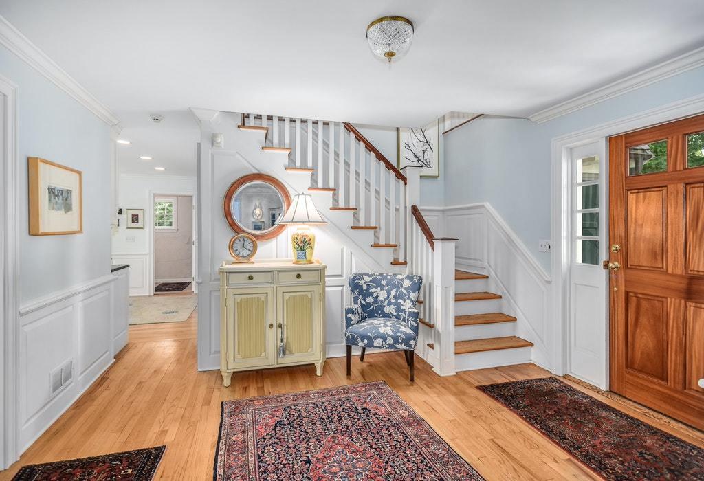 123 Long Neck Point Road Darien, CT 06820 - Photo 18 of 41 a living room with furniture and a clock