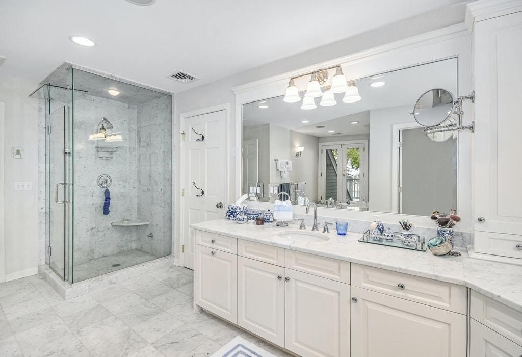 123 Long Neck Point Road Darien, CT 06820 - Photo 20 of 41 a bathroom with a shower sink double and mirror