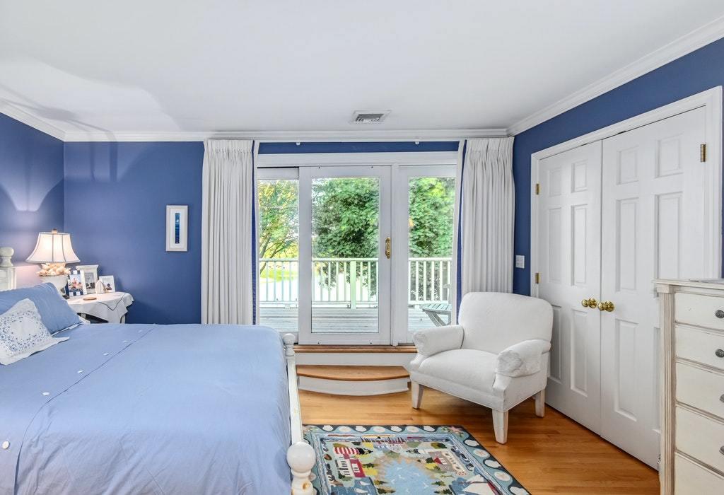 123 Long Neck Point Road Darien, CT 06820 - Photo 23 of 41 a bedroom with furniture and a large window