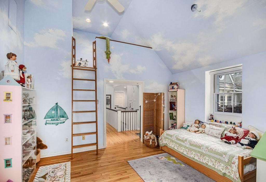 123 Long Neck Point Road Darien, CT 06820 - Photo 29 of 41 a spacious bedroom with a bed a couch and a potted plant